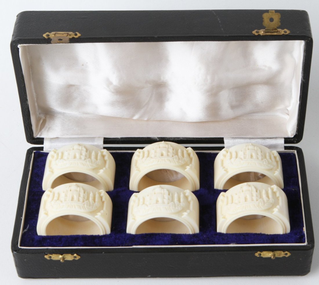 CASED SET 20TH CENTURY INDIAN IVORY NAPKIN RINGS: CASED SET 20TH CENTURY INDIAN IVORY NAPKIN RINGS Ivory napkin rings, each with a carved depiction of the Taj Mahal. Contained in a velvet lined, leather look box. Size: Box 8" x 4" x 2.5" **Please be 