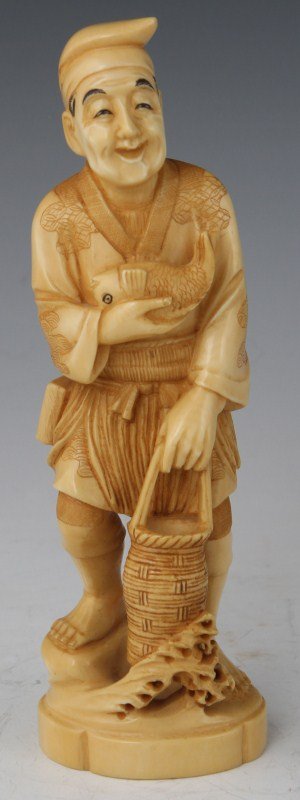 JAPANESE CARVED IVORY FISHERMAN OKIMONO SIGNED: JAPANESE CARVED IVORY FISHERMAN OKIMONO SIGNED Ivory Japanese figure of a fisherman with etched and stained details. Fisherman is holding a fish in one hand and a fishing basket in the other. Small sa