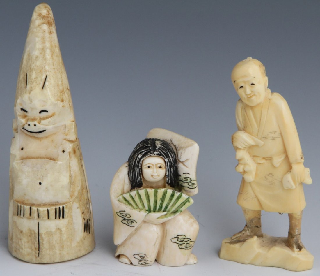 THREE CARVED IVORY FIGURES JAPANESE ESKIMO: THREE CARVED IVORY FIGURES JAPANESE ESKIMO A lot of three carved ivory pieces. A polychrome stained ivory netsuke, female mask dancer with rotating head, holding a fan and wearing robes etched with cl