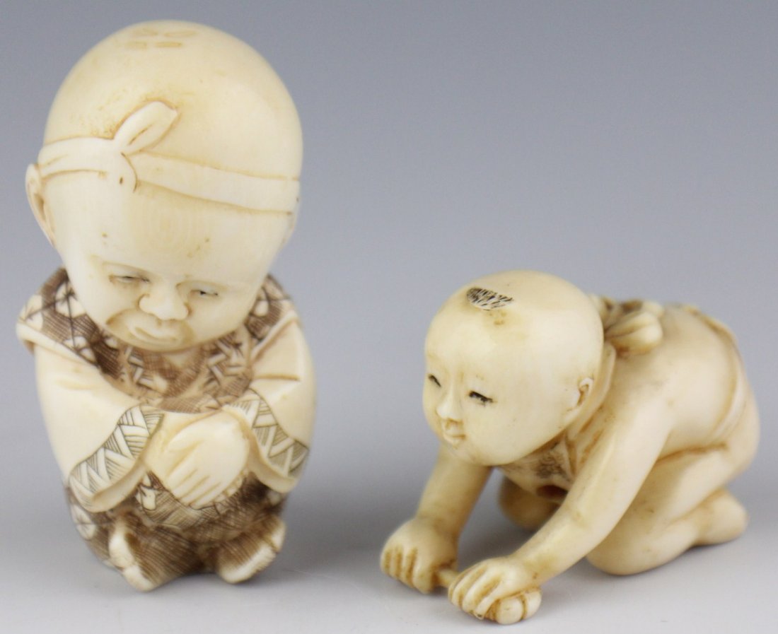 CARVED IVORY NETSUKE CHILDREN SIGNED: CARVED IVORY NETSUKE CHILDREN SIGNED Two carved ivory child netsuke. The first is a crawling baby, wearing only an apron and holding a flower in its hands. The second is a seated child in etched robes