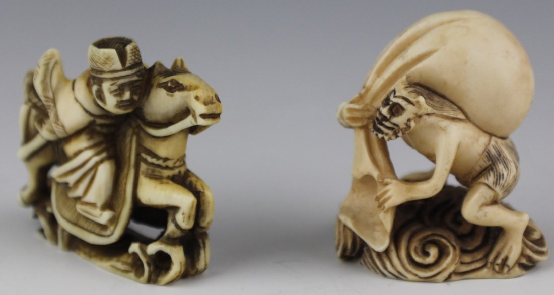 CARVED IVORY NETSUKE ONI RIDER SIGNED: CARVED IVORY NETSUKE ONI RIDER SIGNED Two carved ivory netsuke, both etched and stained. The first is a demon oni, walking on water or smoke with a large sack on its back. The second is a figure on ho