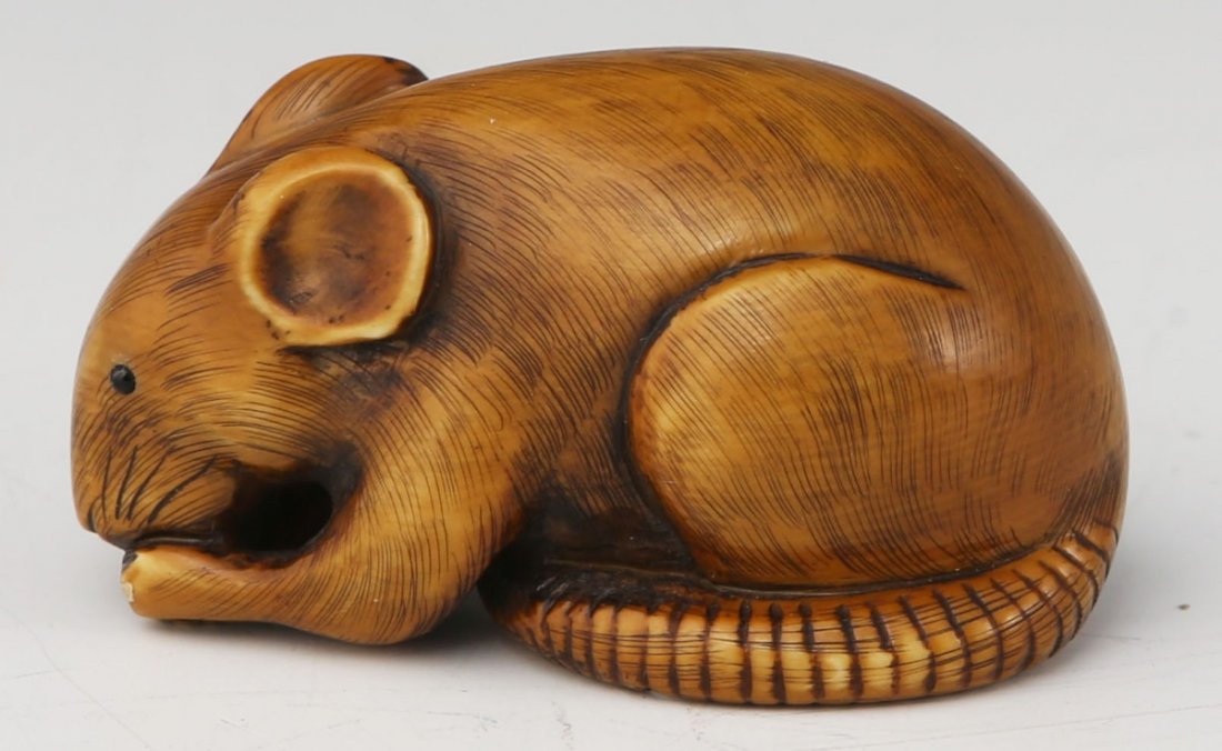 JAPANESE CARVED IVORY NETSUKE OF A MOUSE: JAPANESE CARVED IVORY NETSUKE OF A MOUSE Carved ivory mouse, eating. Signed by the artist. Size: 2" **Please be advised: International shipping it NOT permitted on items containing Ivory** Thank you.