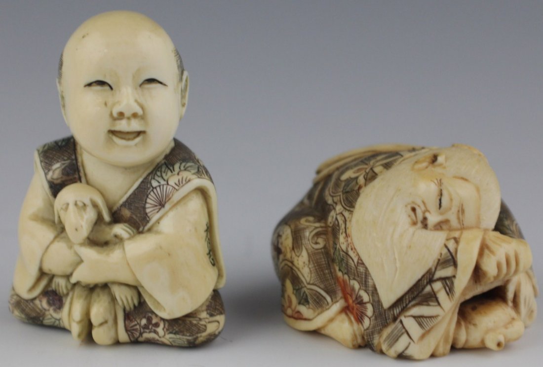 CARVED IVORY SIGNED NETSUKE AND OKIMONO: CARVED IVORY SIGNED NETSUKE AND OKIMONO Two carved ivory male figures, one an okimono, the other a netsuke. The okimono features a seated man with an oversized head, in polychrome stained and etched r