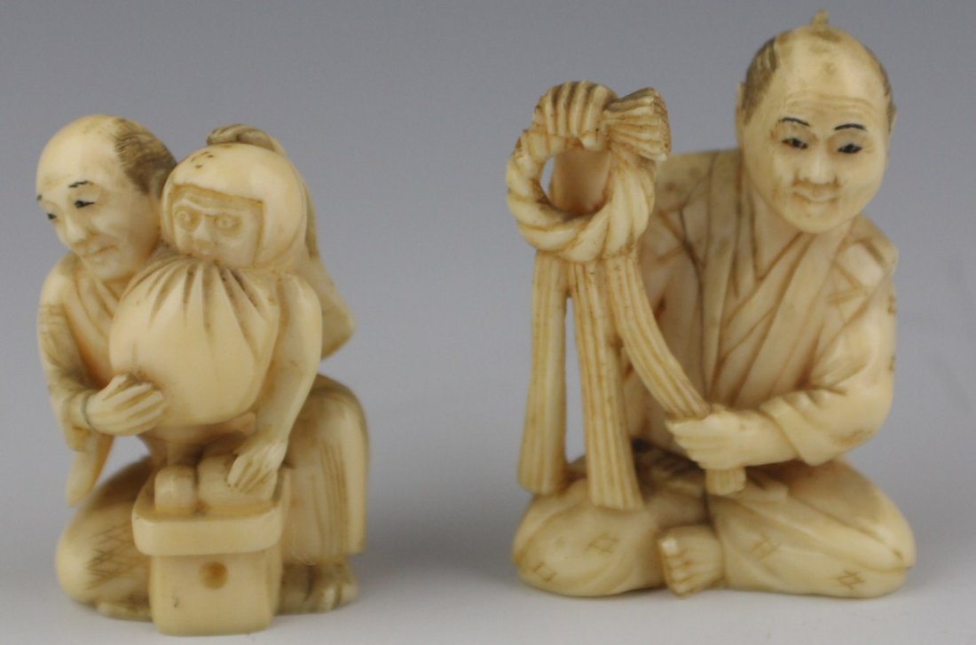 PAIR OF CARVED IVORY NETSUKE FIGURES: PAIR OF CARVED IVORY NETSUKE FIGURES Two seated carved ivory netsuke, men wearing kimono holding various items up for display. One signed to base. Size: 2" **Please be advised: International shipping 