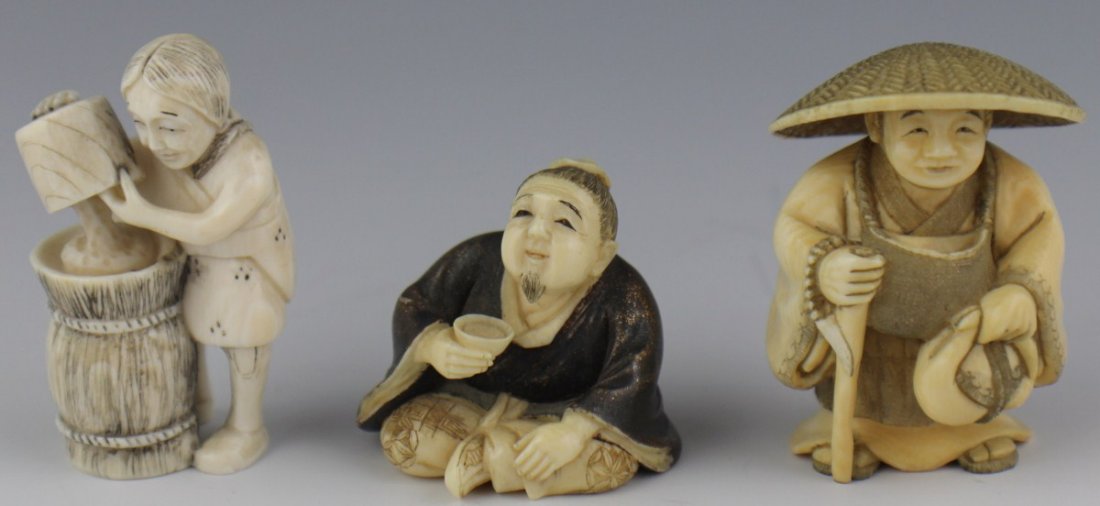 THREE CARVED SIGNED IVORY NETSUKE: THREE CARVED SIGNED IVORY NETSUKE Three carved ivory netsuke, all signed to the base. A seated man, enjoying his tea, a figure emptying the contents of a bucket into a barrel, and a peasant in conical