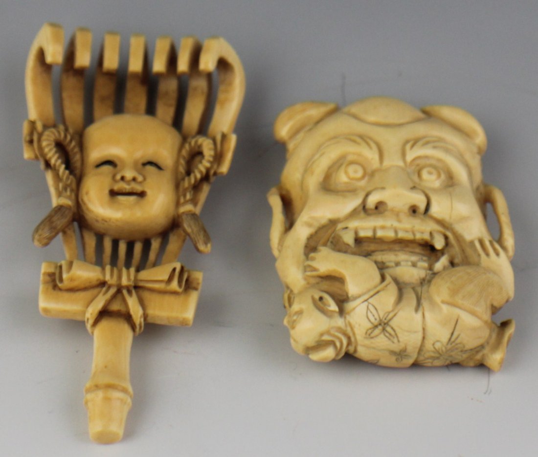 TWO CARVED IVORY NETSUKE MASKS: TWO CARVED IVORY NETSUKE MASKS Two carved ivory masks, size of netsuke figures. The first is a rake with the mask of a boy centered on it. A bow and rope loops trim the rake. Lightly stained, highly p