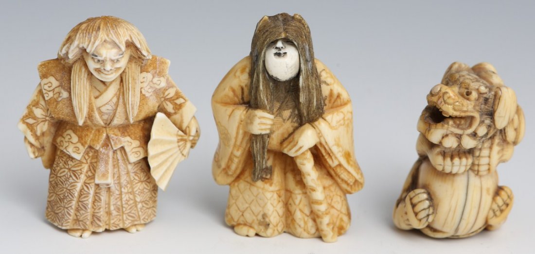 LOT OF 3 JAPANESE CARVED IVORY NETSUKES: LOT OF 3 JAPANESE CARVED IVORY NETSUKES Two are signed, one with revolving face, minor damage to the other. The third is carved in the form of a Foo dog and appears to be much earlier. Size: 1.5" to 2