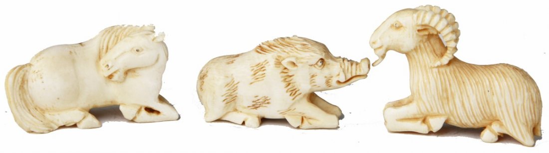 THREE CARVED IVORY RECUMBENT ANIMAL NETSUKE: THREE CARVED IVORY RECUMBENT ANIMAL NETSUKE Three carved ivory animals, all in recumbent positions. Included is a horse, wild boar and mountain goat. All three have etched hair and visible facial feat