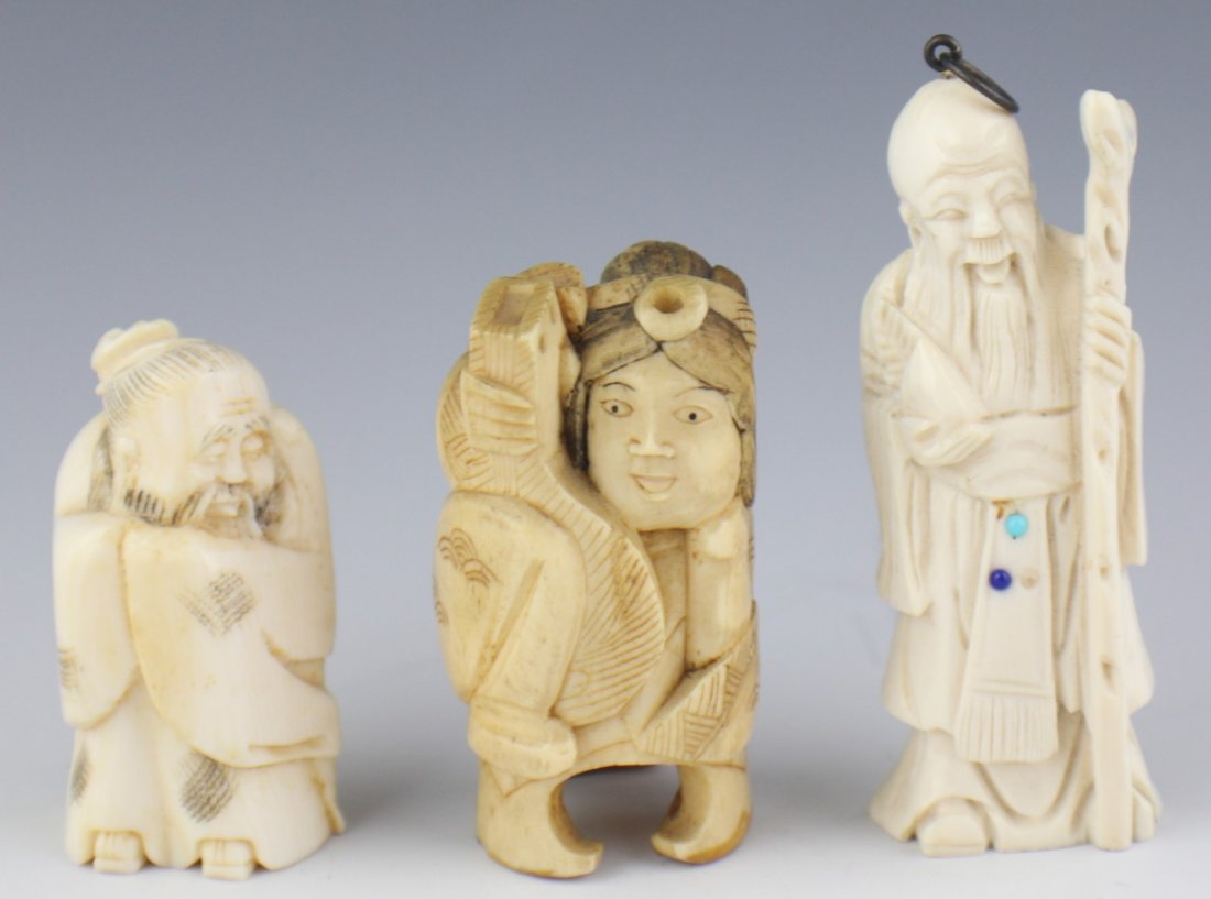 CARVED IVORY AND BONE NETSUKE FIGURES: CARVED IVORY AND BONE NETSUKE FIGURES Two carved ivory figures, one sleeping sage, one standing sage with staff and beaded sash. The bone figure is a seated female musician holding her string instrume