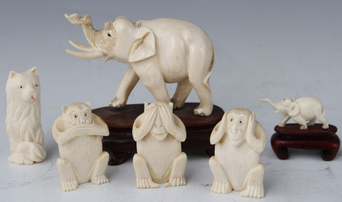 CARVED IVORY ANIMAL FIGURES LOT: CARVED IVORY ANIMAL FIGURES LOT A lot of carved ivory animal figures. Two elephants, one miniature the other larger, both in mid stride with trunks raised above pointed tusks. Both mounted to wooden s