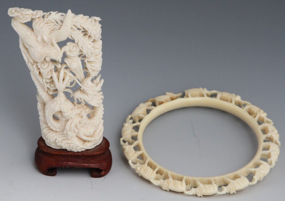 CARVED IVORY BRACELET AND BATTLE SCENE: CARVED IVORY BRACELET AND BATTLE SCENE A carved ivory bangle bracelet formed of an ivory ring on which fourteen Elephants stand trunk to tail. Also, a carved Ivory tusk displaying a traditional scene