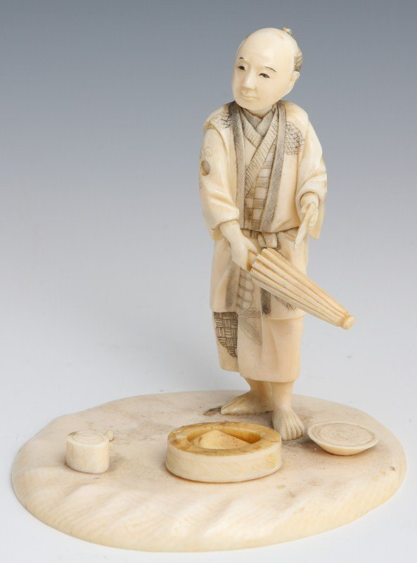CHINESE CARVED IVORY FIGURE OF A MAN: CHINESE CARVED IVORY FIGURE OF A MAN Figural carved ivory diorama showing a man cleaning a parasol. Size: 4" tall **Please be advised: International shipping it NOT permitted on items containing Ivory