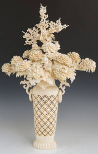 A DELICATE CHINESE CARVED IVORY VASE OF FLOWERS: A DELICATE CHINESE CARVED IVORY VASE OF FLOWERS Delicately carved, pierced flower vase, created from ornately carved ivory pieces and formed into a floral display. Size: Over 22" tall, 4.19 lbs 