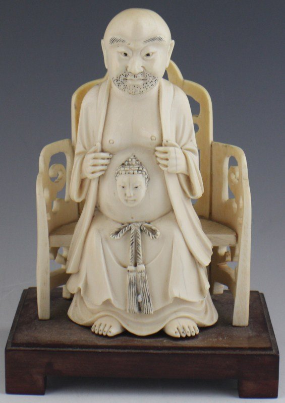 CHINESE CARVED IVORY SEATED MAN FIGURE: CHINESE CARVED IVORY SEATED MAN FIGURE Carved ivory figure of a seated man with a Buddha head protruding from the belly. Size: 7" tall **Please be advised: International shipping it NOT permitted on i