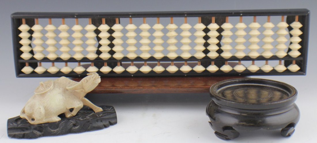 JAPANESE BONE ABACUS & BULL & TWO WOOD BASES: JAPANESE BONE ABACUS & BULL & TWO WOOD BASES Small lot of Japanese items. A bone disc abacus. 21 rows of 6 discs. A cast composite bull on a black wood stand. A vase base and a display stand. Size: 12
