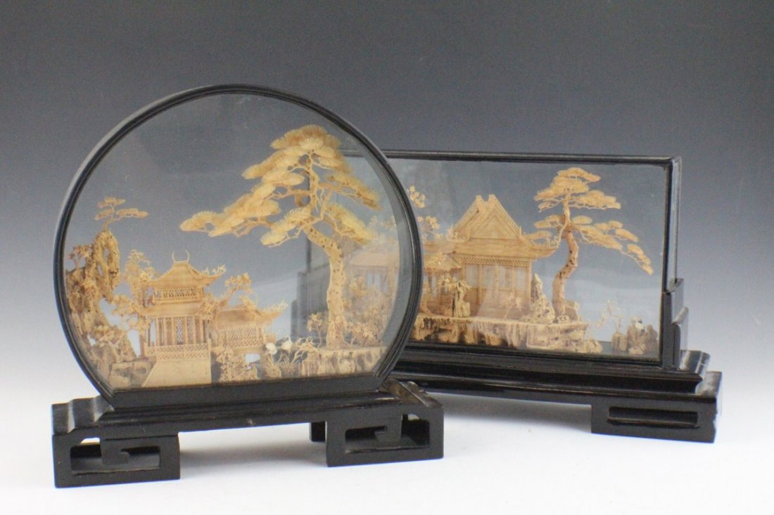 LOT OF TWO ASIAN CARVED CORK VILLAGES: LOT OF TWO ASIAN CARVED CORK VILLAGES Two carved cork Asian scenes, made in China. Both are contained in glass and affixed to black wooden stands. Size: 9 x 9"; 12.5 x 7"