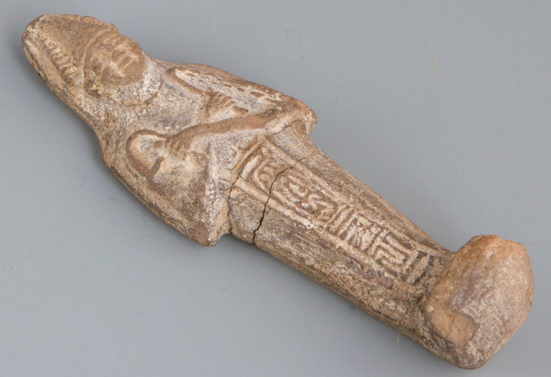 EARTHENWARE EGYPTIAN USHABTI: EARTHENWARE EGYPTIAN USHABTI A 6" earthenware Egyptian ushabti funerary figure. Arms are crossed, and the lower portion of the body features hieroglyphs. Size: 6"