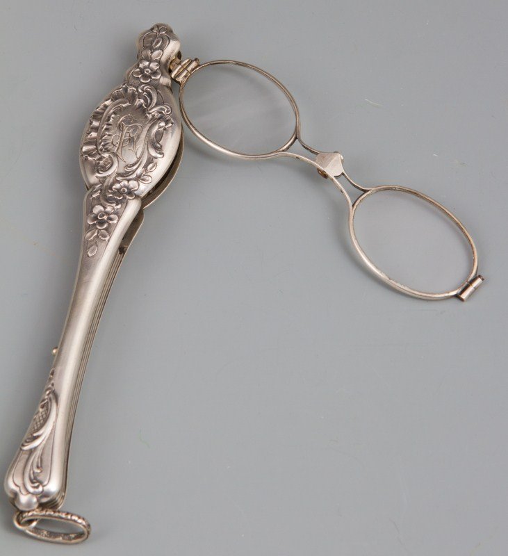 STERLING REPOUSSE FOLD OUT GLASSES: STERLING REPOUSSE FOLD OUT GLASSES A pair of fold out eye glasses in sterling repousse case. Scratches to lenses. Case is engraved with an "R". Hallmarks to side features the initials J and S and a tr