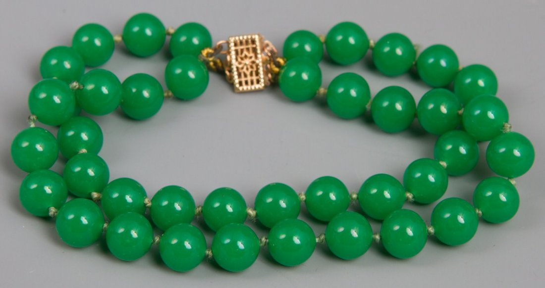 MIRIAM HASKELL FAR EAST JADE BRACELET 14K CLASP: MIRIAM HASKELL FAR EAST JADE BRACELET 14K CLASP Vintage Miriam Haskell Far East jade double strand bracelet, hand tied individually knotted with 14k gold floral clasp. Comes with original box. Weight: