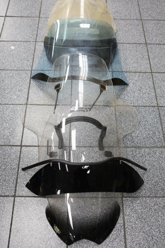 A SELECTION OF MOTORCYCLE WIND SHIELDS: A SELECTION OF MOTORCYCLE WIND SHIELDS Plexiglass wind screens, lot of 7 Size: Various