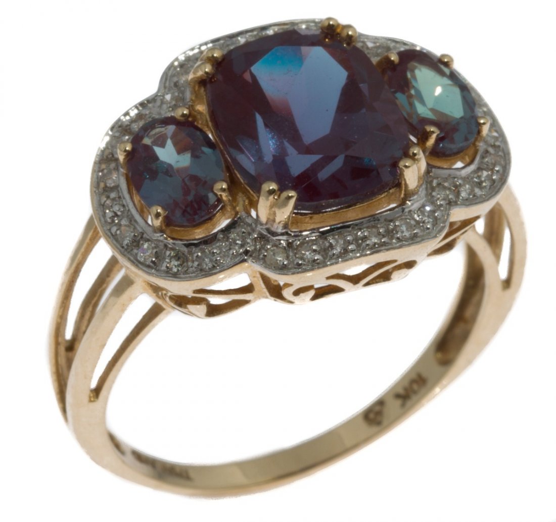 LADIES 10K YELLOW GOLD FASHION RING: LADIES 10K YELLOW GOLD FASHION RING Ladies 10K yellow gold fashion ring with a cushion cut synthetic alexandrite accented with 2 oval cut synthetic alexandrites and surrounded by a halo of 32 small ro