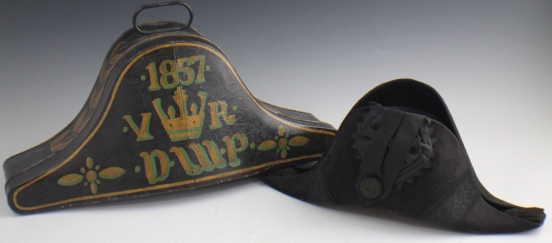 ROYAL NAVY BICORN HAT AND METAL CASE: ROYAL NAVY BICORN HAT AND METAL CASE Royal Beaver skin bicorn hat with red silk lining and gilt metal case. Dated 1857 accompanied by the Crown of the Royal Navy.