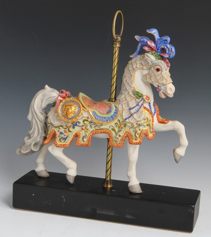 CYBIS PORCELAIN CAROUSEL HORSE #104: CYBIS PORCELAIN CAROUSEL HORSE #104 Porcelain carousel horse figurine by Cybis. Detailing on the horse's attire is very intricate and regal, with blues, pinks, greens and gold outlining. Size: 12" by