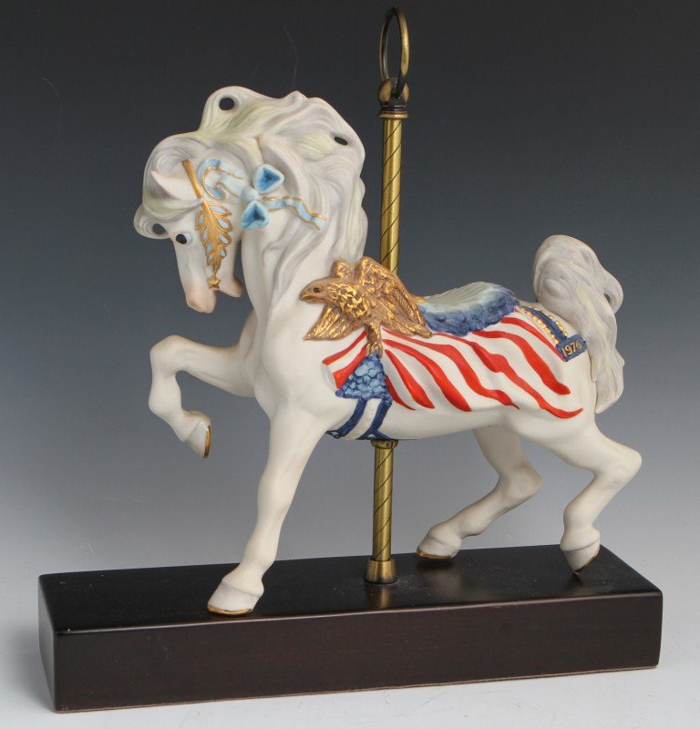CYBIS PORCELAIN CAROUSEL HORSE #484: CYBIS PORCELAIN CAROUSEL HORSE #484 Porcelain carousel horse figurine by Cybis. White horse with American flag motif on its saddle. Saddle has stars and stripes and gold eagle. Size: 12" by 13"