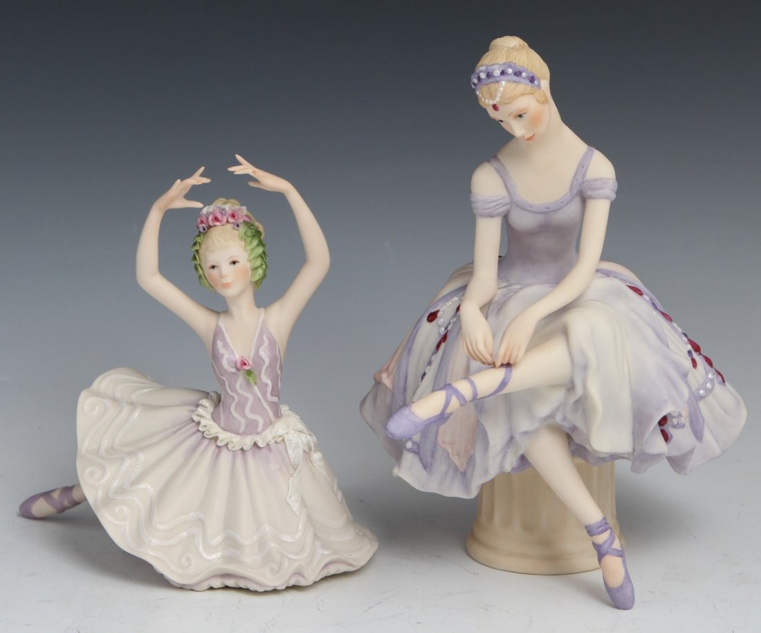 LOT OF TWO CYBIS PORCELAIN BALLERINA FIGURINES: LOT OF TWO CYBIS PORCELAIN BALLERINA FIGURINES Two porcelain ballerina figurines by Cybis. One ballerina is re-fastening her point shoe, and the other is mid-pose. Both are in purple costumes. Size: 9