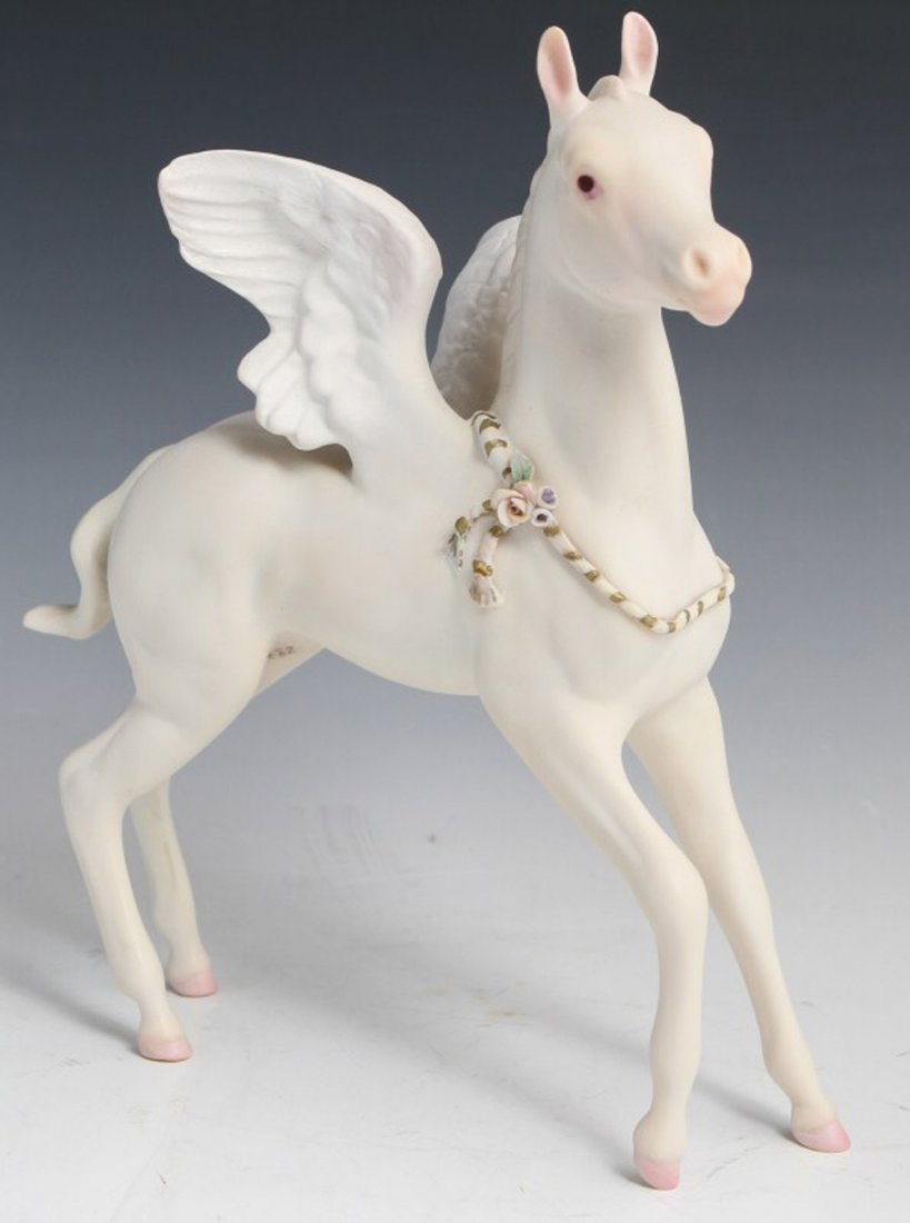 CYBIS FREE SPIRIT PEGASUS PORCELAIN FIGURE: CYBIS FREE SPIRIT PEGASUS PORCELAIN FIGURE Porcelain figure of a Pegasus with a decorative rope by Cybis dated 1980 on bottom. Free Spirit, #665. Signed on base. Small chip on left wing. Size: 9"