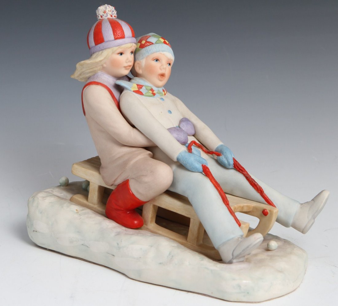 CYBIS NANCY AND NED PORCELAIN FIGURE: CYBIS NANCY AND NED PORCELAIN FIGURE Porcelain figure of a young boy and his sister sledding by Cybis dated 1978 on bottom; Nancy and Ned. Signed on base. Size: 8"