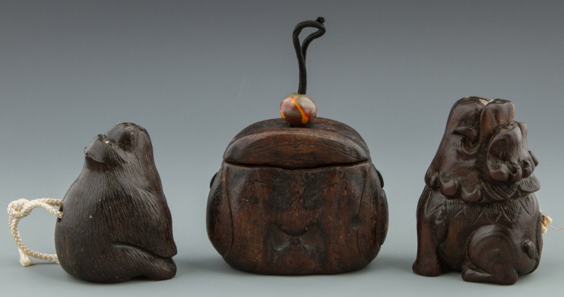 JAPANESE CARVED WOOD NETSUKE AND INRO LOT: JAPANESE CARVED WOOD NETSUKE AND INRO LOT Lot of three traditional carved Japanese belt sagemono items: two netsuke and one inro. The netsuke are of animal form, both with snouts directed upwards and 
