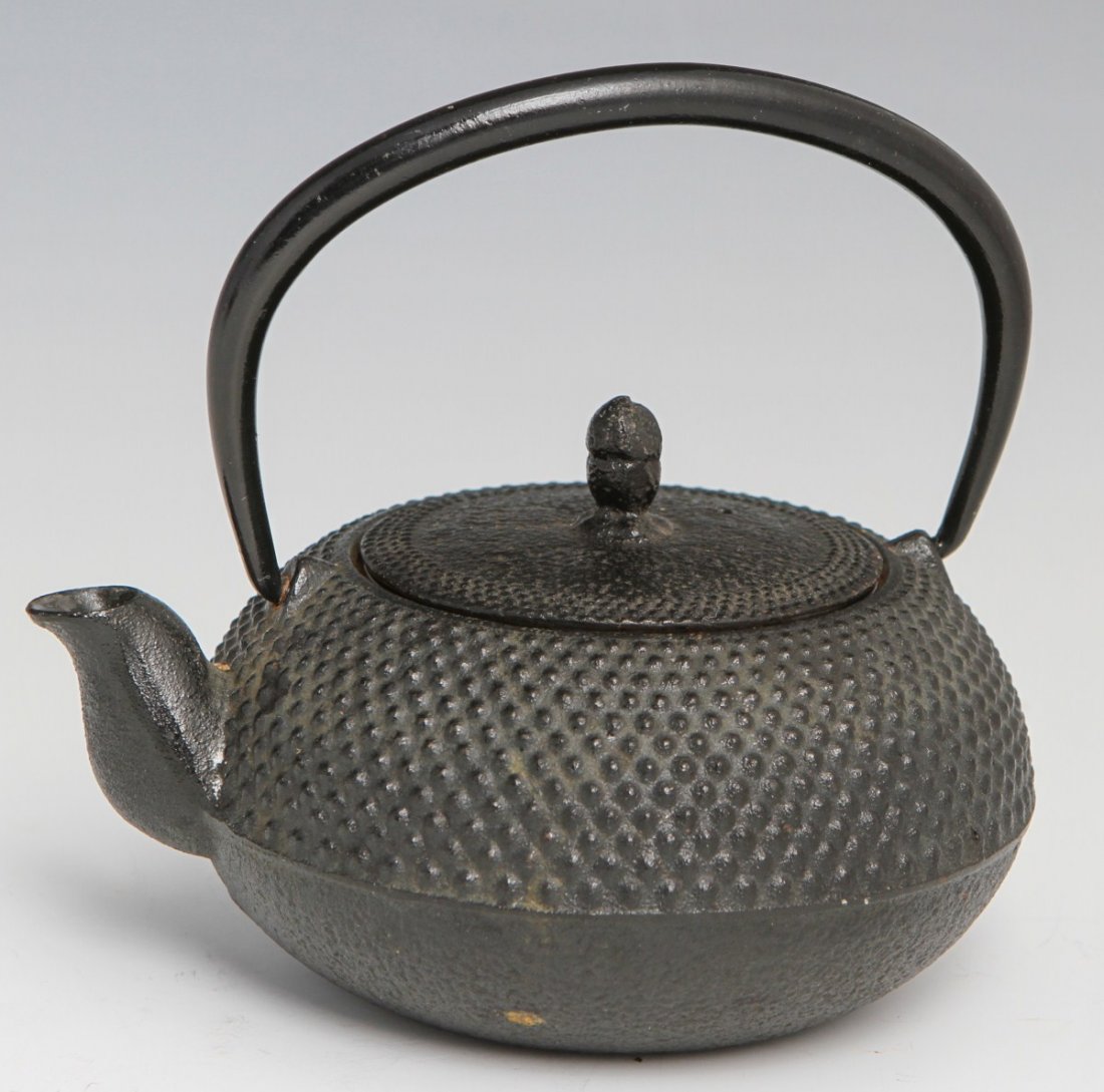 CAST IRON JAPANESE KYUSU TEA POT: CAST IRON JAPANESE KYUSU TEA POT Small cast iron Japanese kyusu tea pot with raised cipher signature. Includes infuser. Size: 5"l