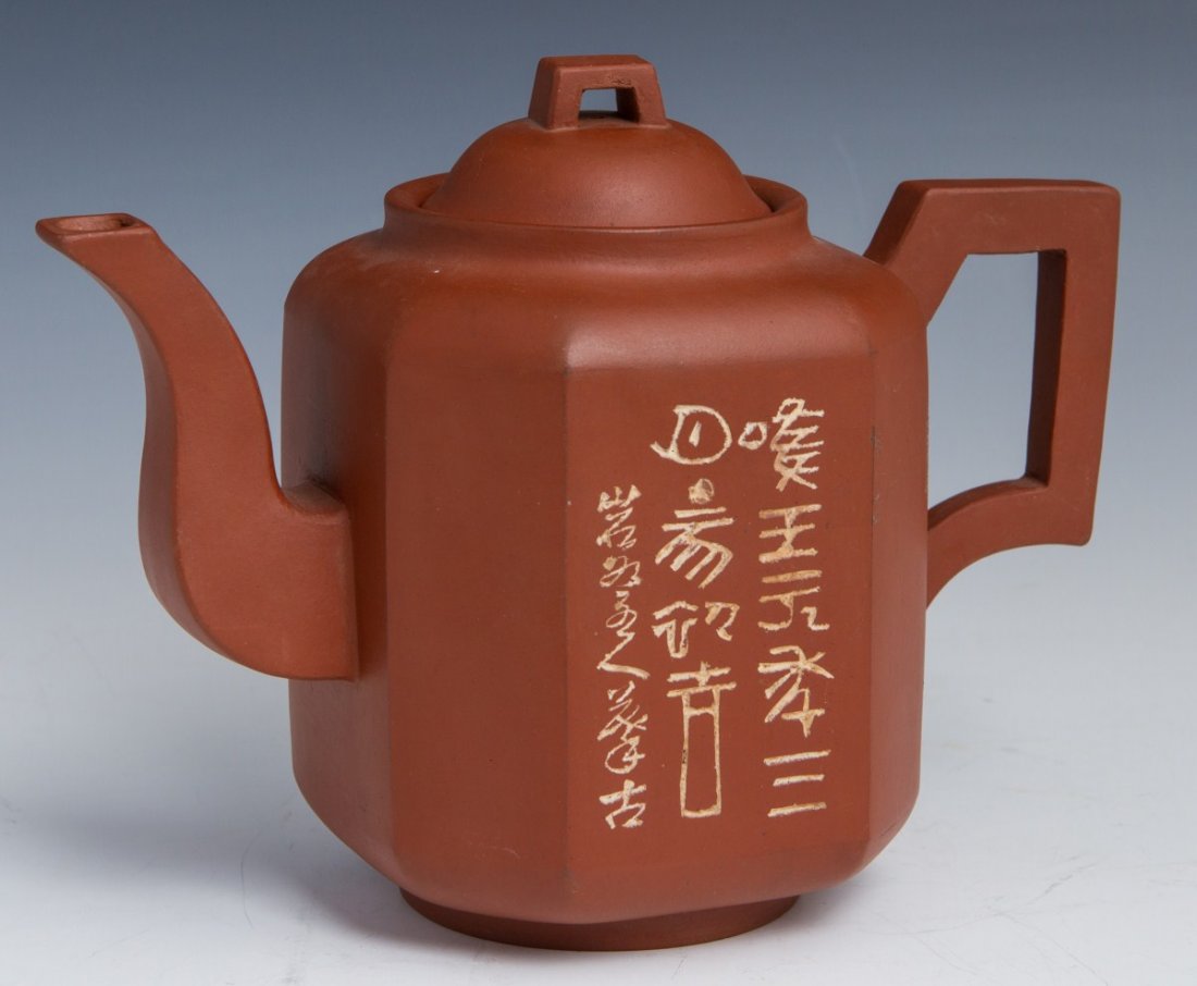 ZISHA YIXING SUTRA TEAPOT CHINA: ZISHA YIXING SUTRA TEAPOT CHINA Octagonal redware teapot from Yixing China. Features sutra on one side and picture on the other. Bottom stamped "Made in China". Early 20th century. Size: 7 x 9 x 4.5"
