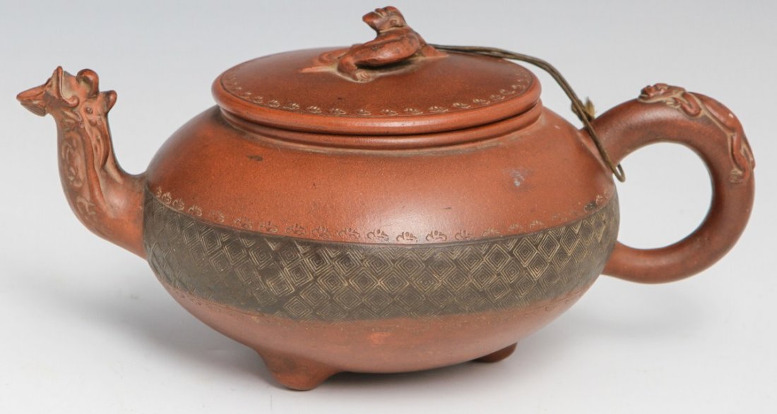 CHINESE YIXING ZISHA TEAPOT LIZARD MOTIF 19TH CENT: CHINESE YIXING ZISHA TEAPOT LIZARD MOTIF 19TH CENT 19th century zisha teapot from Yixing China. Lizard motif with lid (fastened to handle via knob). Overall good condition with some chips to the spout