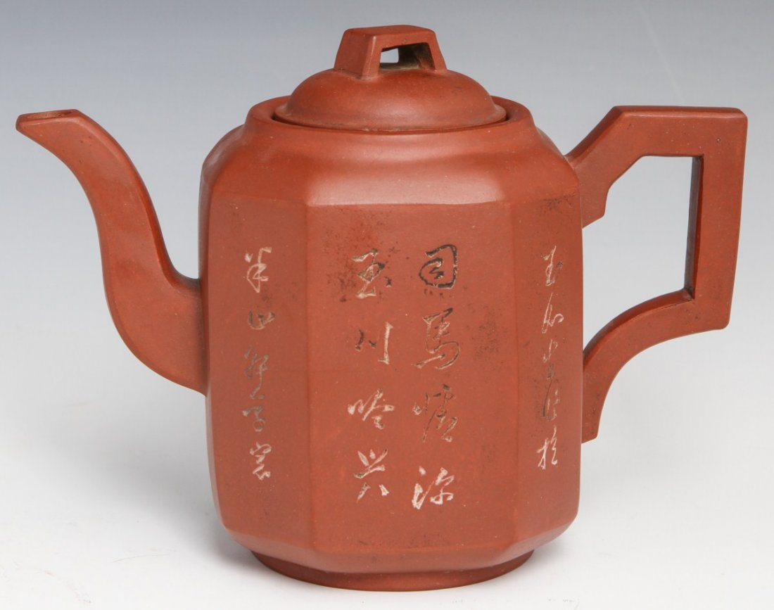 YIXING SUTRA TEAPOT REDWARE CHINA: YIXING SUTRA TEAPOT REDWARE CHINA Octagonal redware teapot from Yixing China. Features sutra on one side and picture on the other. No marks, several chips to rim of lid. Early 20th century. Size: 6 x