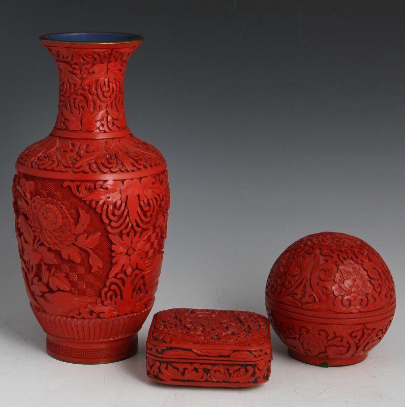 LOT OF CHINESE CINNABAR ITEMS: LOT OF CHINESE CINNABAR ITEMS A lot of three Chinese cinnabar decorative items. Includes vase with blue enamel lining, 10"; round trinket box, 4"; square ink-slab box/dresser box, 4".