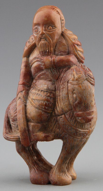 JAPANESE CARVED NEPHRITE JADE NETSUKE: JAPANESE CARVED NEPHRITE JADE NETSUKE Japanese carved jade netsuke figure of a Mongolian horseman with armor mounted on steed. Great detail to horse and armor. Size: 2 3/4 Weight: 66 g