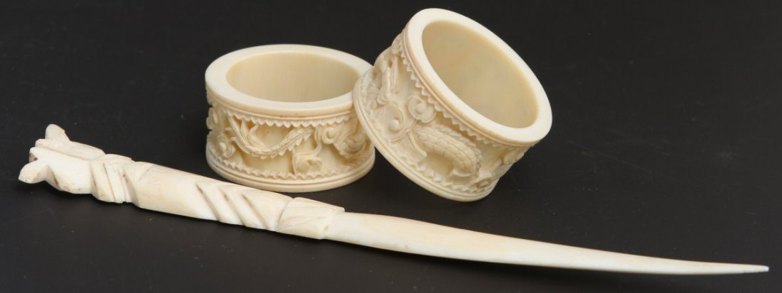 PAIR OF CARVED IVORY NAPKIN RINGS & LETTER OPENER: PAIR OF CARVED IVORY NAPKIN RINGS & LETTER OPENER Pair of ivory napkin rings carved with image of Chinese dragon. Also included in the lot is a carved ivory letter opener. Size: Rings 1"h, 2"diam; Ope