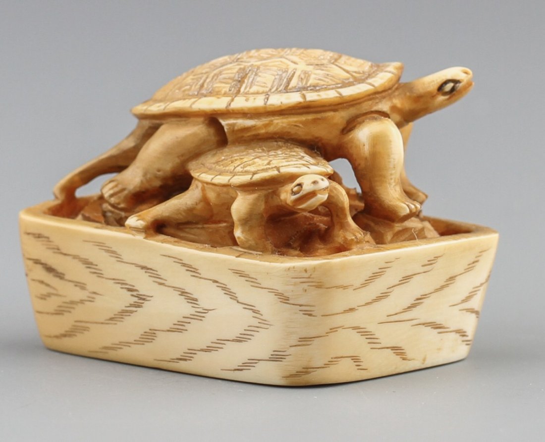 JAPANESE CARVED IVORY NETSUKE TURTLES: JAPANESE CARVED IVORY NETSUKE TURTLES Japanese carved ivory netsuke figure of two turtles in a basket, Signed. Size: 1 1/2"l Weight: 33g