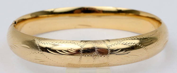 14K GOLD FLORINTINE FINISH BANGLE BRACELET: Ladies 14k yellow gold Italian manufactured bangle bracelet. Properly factory stamped .585/ 14k gold. 10.5mm wide with engraved floral Florentine finish. Size: 7". 14.6GRAMS. Must be paid by