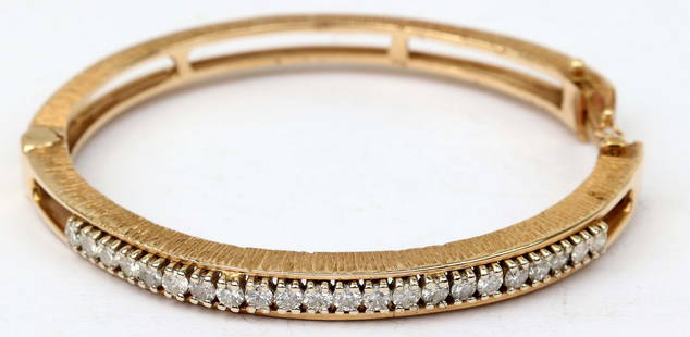 14K YELLOW GOLD DIAMOND BANGLE BRACELET: Ladies 14k yellow gold diamond bangle bracelet. 5.34 mm wide. Twenty two .05 ct diamonds totaling 2/3 of a carat of natural diamonds H color Vs clarity. Size: 6.5" 24.8GRAMS Must be paid by