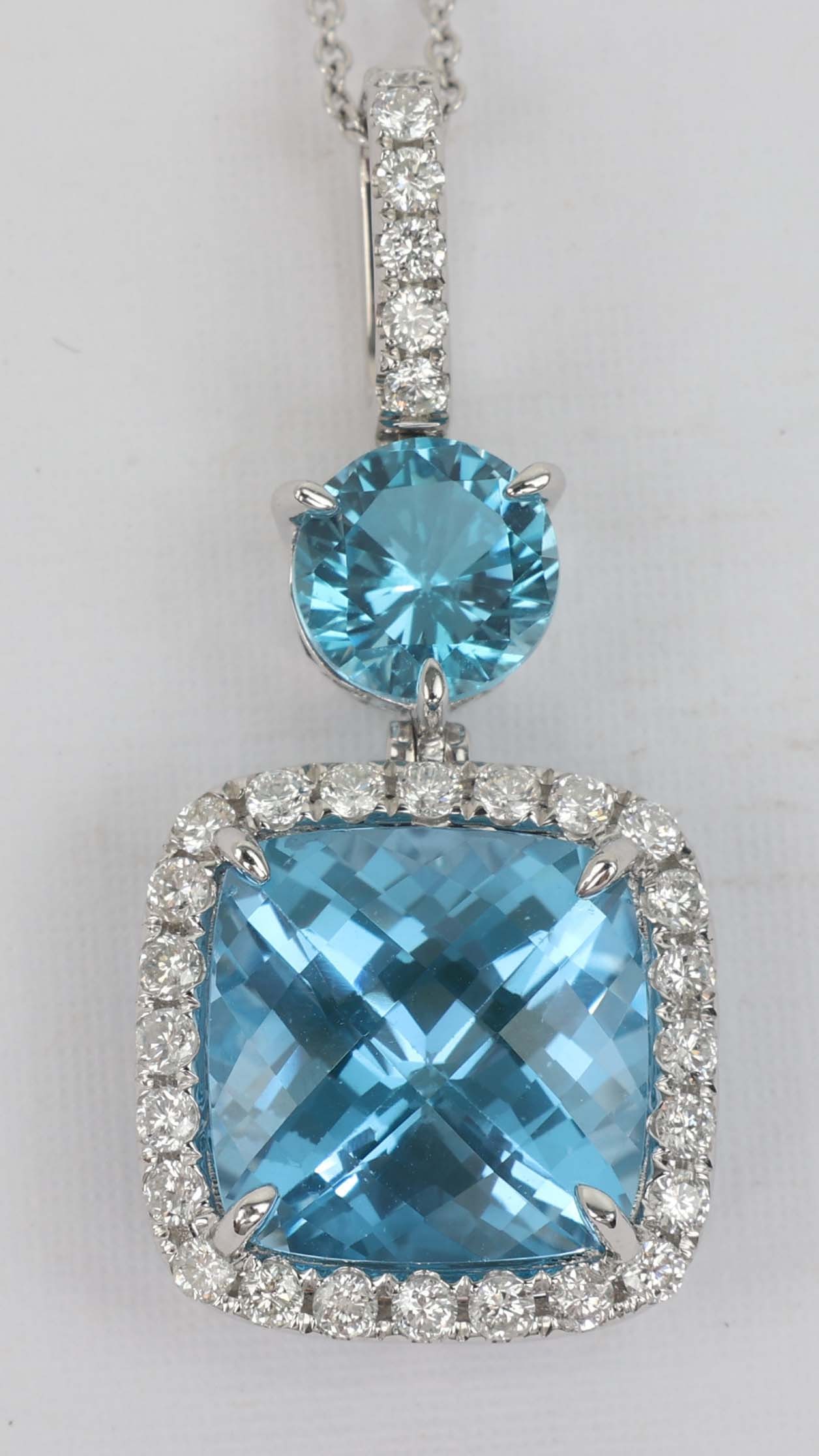 14K MICHAEL CHRISTOFF BLUE TOPAZ DIAMOND PENDANT: 14k white gold Michael Christoff Diamond and Blue Topaz pendant. 30 round diamonds .74ct 2 Blue Topaz 10.93 ct. Length: 16" Grams: 7.0 Must be paid by Certified Check, money order, or wire transfer ($