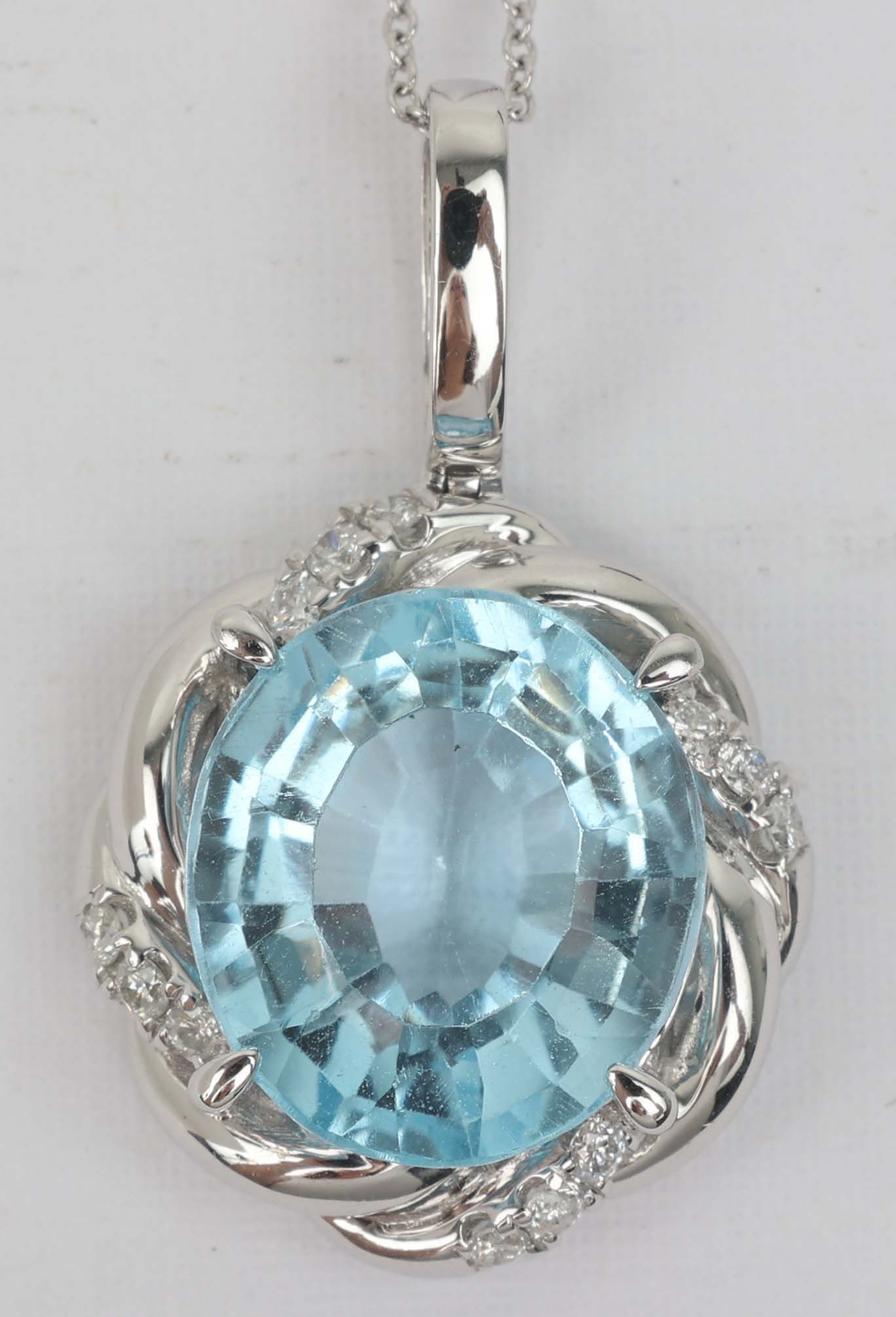 14K MICHAEL CHRISTOFF BLUE TOPAZ DIAMOND PENDANT: 14k white gold Michael Christoff Diamond and Blue Topaz pendant. 12 round diamonds .25ct 1 Blue Topaz 13.67 ct. Grams: 8.0 Length: 18" Must be paid by Certified Check, money order, or wire transfer ($