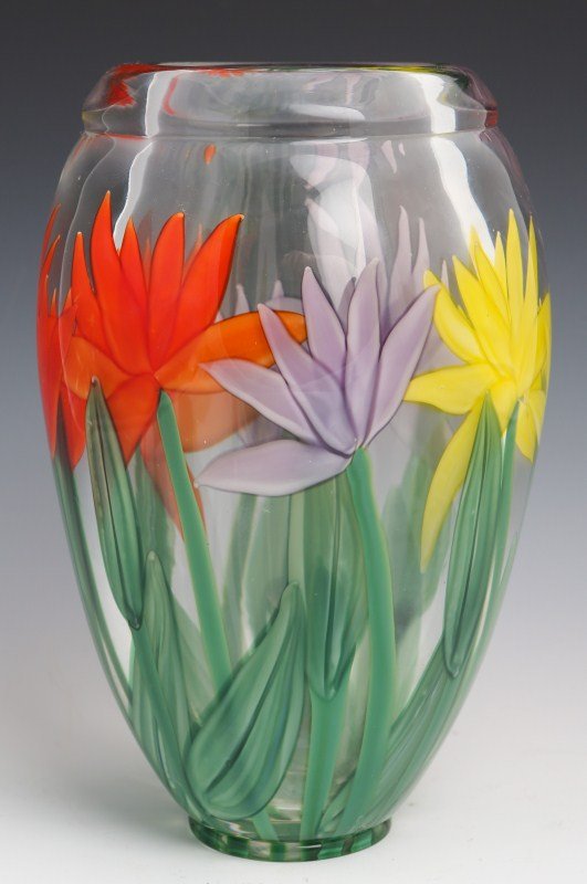 JUSTIN LUNDBERG ART GLASS VASE - SIGNED 1/1: JUSTIN LUNDBERG ART GLASS VASE - SIGNED 1/1 Unique example. A tall example of this attractive paperweight style vase. With bright yellow, orange and purple flowers. Signed : (Justin Lundberg signature