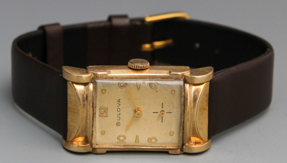 BULOVA 1959 MANUAL WRISTWATCH: BULOVA 1959 MANUAL WRISTWATCH Bulova 1959 21 Jewel Manual Wristwatch, 10K rolled gold plated case by Bulova, serial no. D390994, gold toned hour, minute hands, gold toned art deco numerals and gold fa