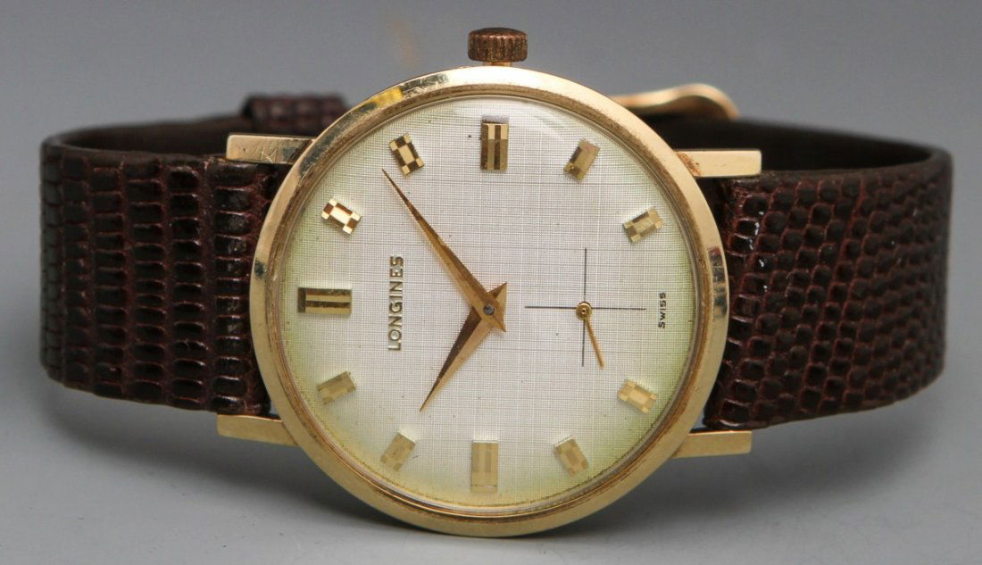 14K LONGINES MANUAL WRISTWATCH: 14K LONGINES MANUAL WRISTWATCH Longines men's manual wristwatch, 14K yellow gold case, gold toned baton numerals with second hand at 6 position. Gold toned hour and minute hands. Brown genuine lizard