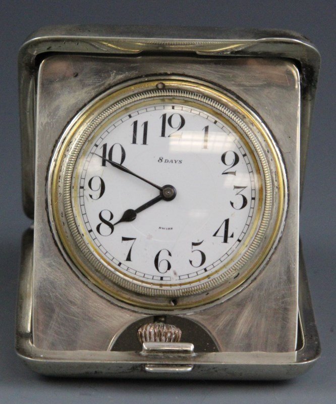 ANTIQUE SWISS STERLING TRAVEL CLOCK: ANTIQUE SWISS STERLING TRAVEL CLOCK Antique Swiss, 8-day travel clock with sterling case and decorative enamel inlay. Weight: 253g Size: 3.5 x 2.625"