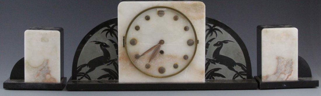 ART DECO (3) PIECE MANTEL CLOCK SET WITH DEER: ART DECO (3) PIECE MANTEL CLOCK SET WITH DEER Three piece Art Deco marble mantel clock set. Minimalist glass and metal clock face, decorated with deer and palm motif; French origin, circa. 1900's. Wor
