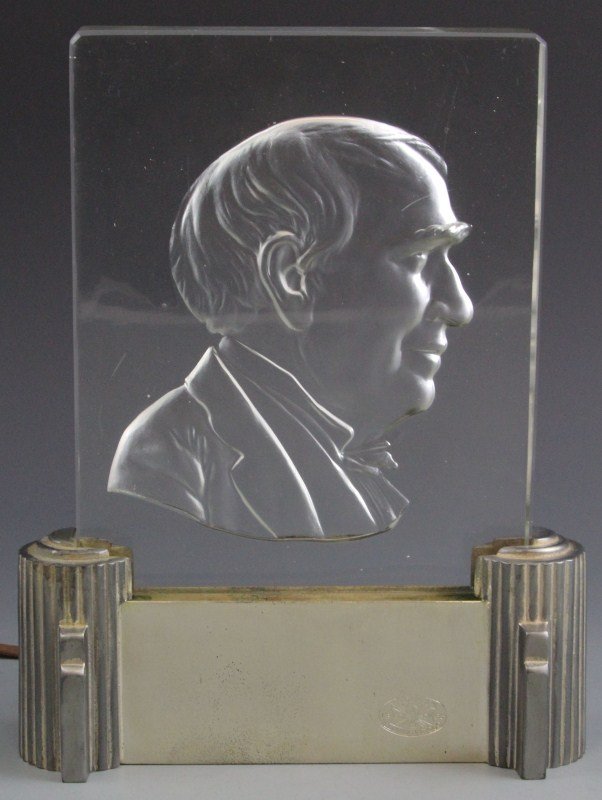 ART DECO EDISON STEUBEN ART GLASS LUMINAIRE: ART DECO EDISON STEUBEN ART GLASS LUMINAIRE Art Deco style metal base with bulb, holds Steuben glass plate (6.5 x 8.5 x .75") with counter relief of Thomas Edison in profile, marked Association Edison